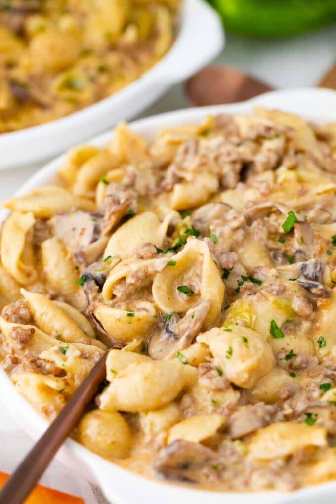 a bowl of instant pot philly cheesesteak pasta made with large shells