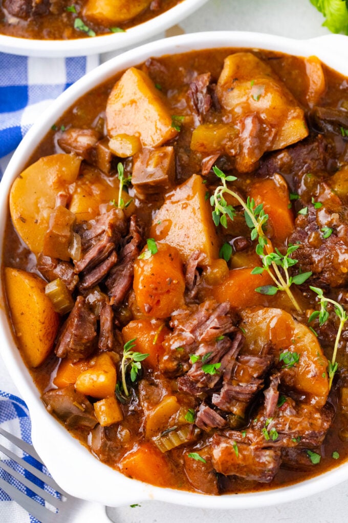 Overhead shot of a bowl of Instant Pot beef Bourguignon with carrots and potatoes.