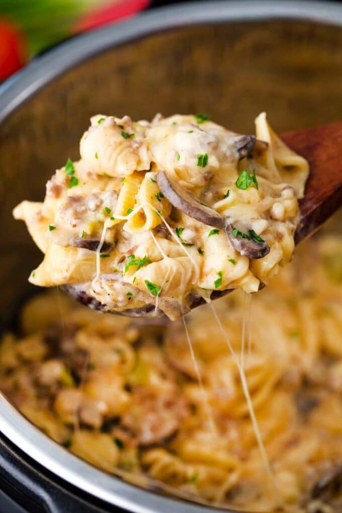 a ladle of very creamy and cheesy instant pot philly cheesesteak pasta