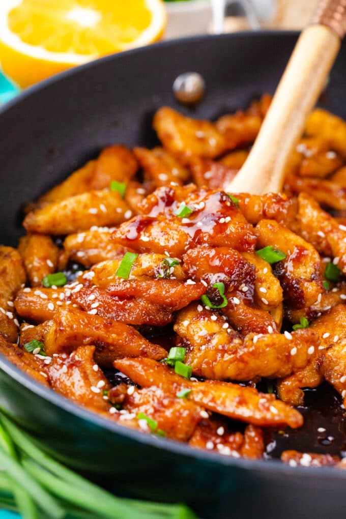 A serving spatula of crispy ginger sesame chicken.