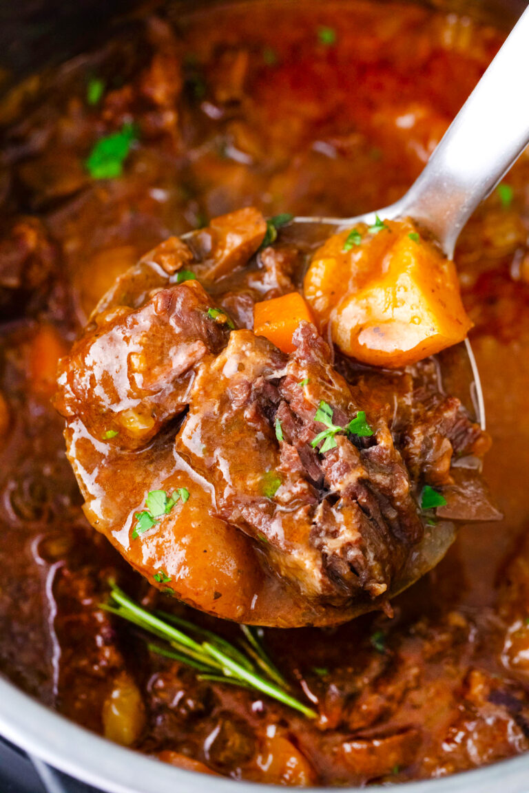 A ladle of juicy Instant Pot beef Bourguignon.
