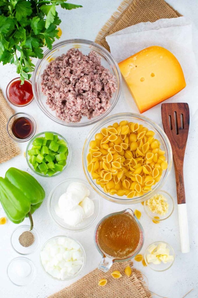 instant pot philly cheesesteak pasta ingredients in bowls on a white surface