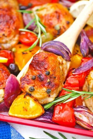 close macro shot of crispy one pan mediterranean chicken thighs and veggies