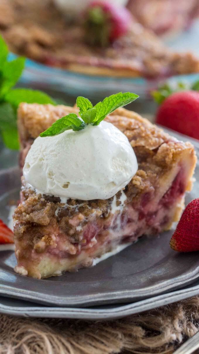 Creamy Strawberry Pie sliced topped with ice cream and a mint leaf