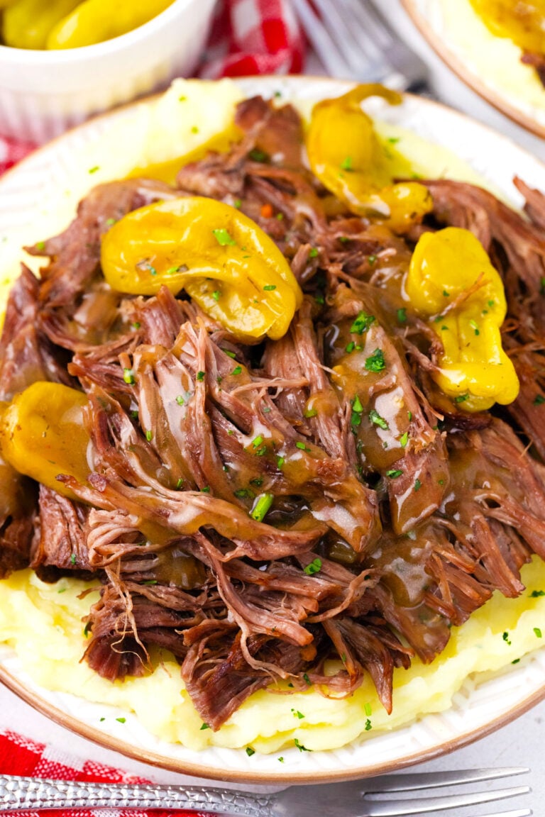 Overhead shot of tender, instant pot Mississippi pot roast over mashed potatoes.