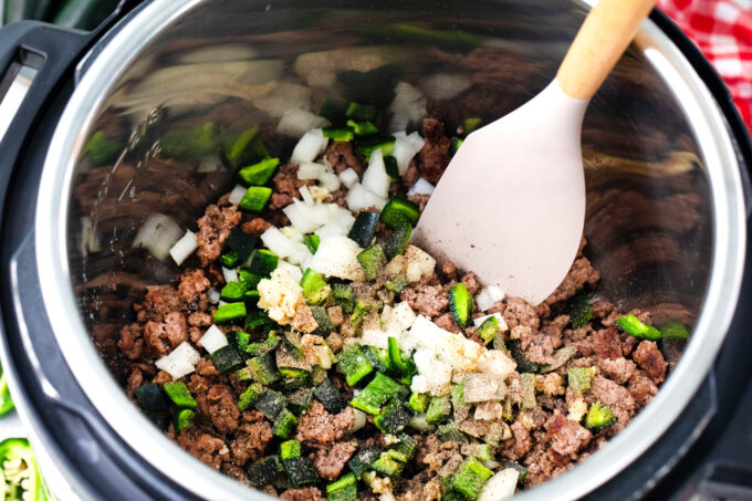 Cooking ground beef with onions and jalapenos in the Instant Pot.
