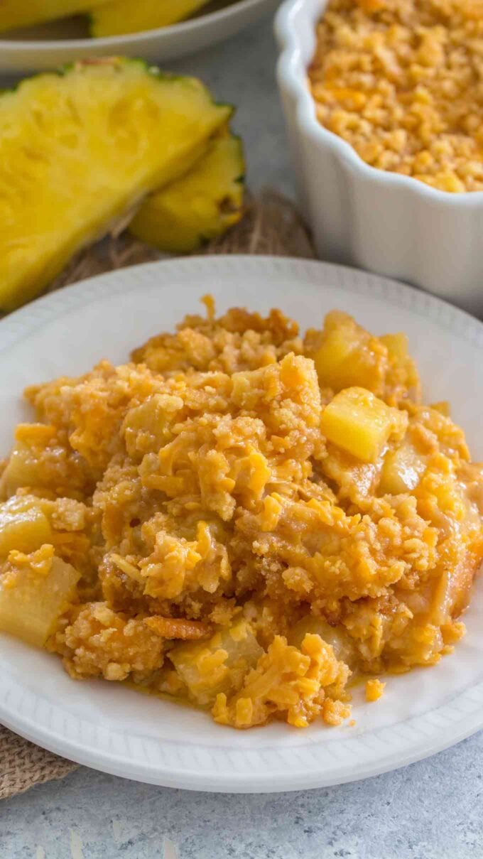 Image of homemade pineapple casserole on a white plate.