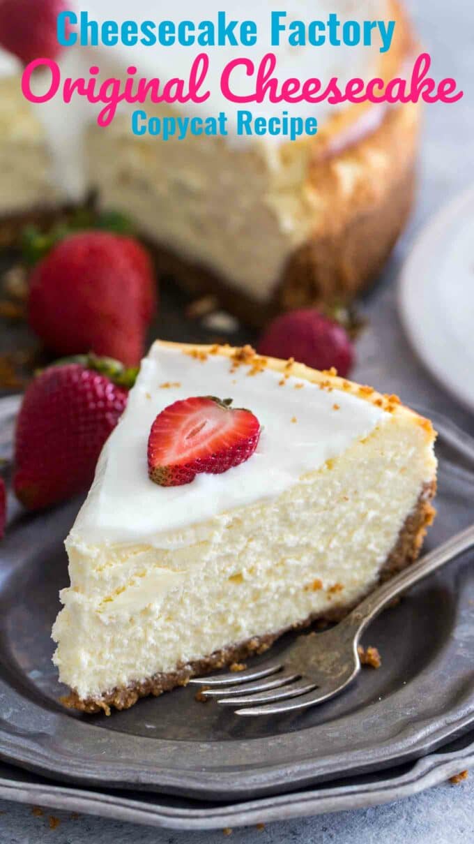 image of a sliced classic cheesecake topped with sliced strawberry on a silver plate