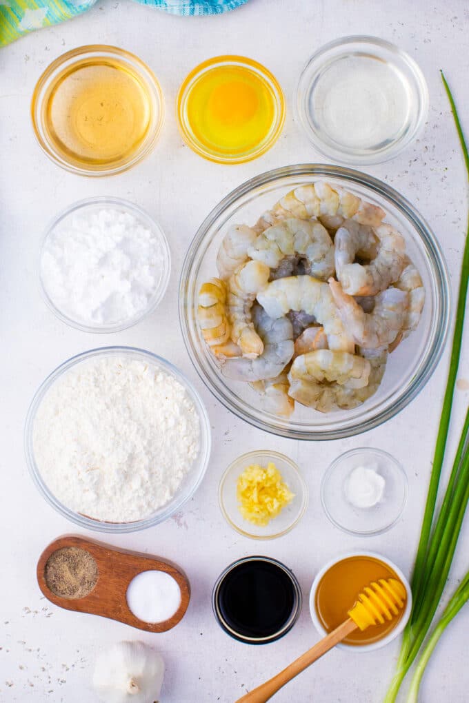 Overhead shot of PF Chang's crispy honey shrimp ingredients in bowls on a table.