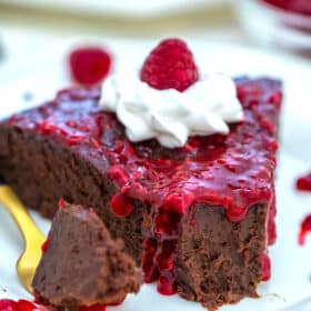 image of low carb chocolate cake with raspberry sauce and whipped cream