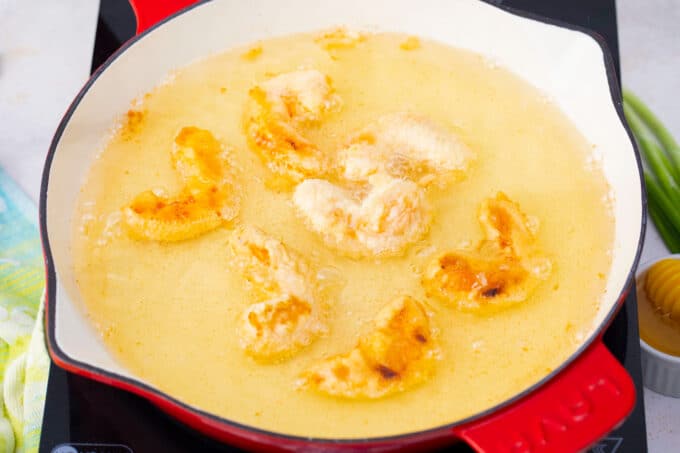 Frying shrimp in a skillet.