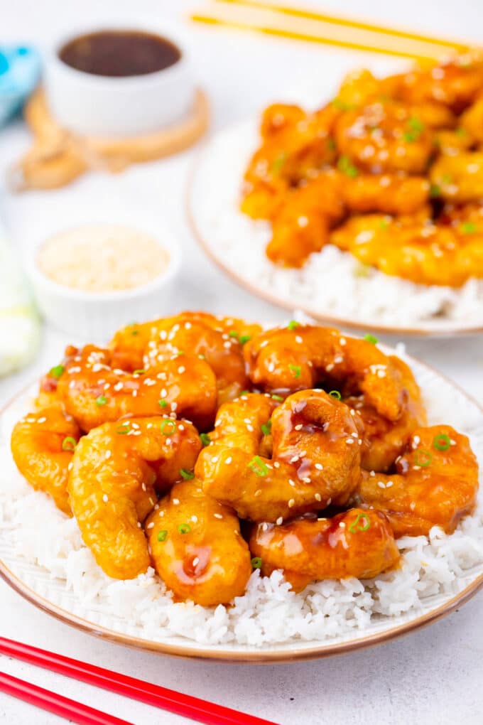 Two serving plates of PF Chang's crispy honey shrimp with rice.
