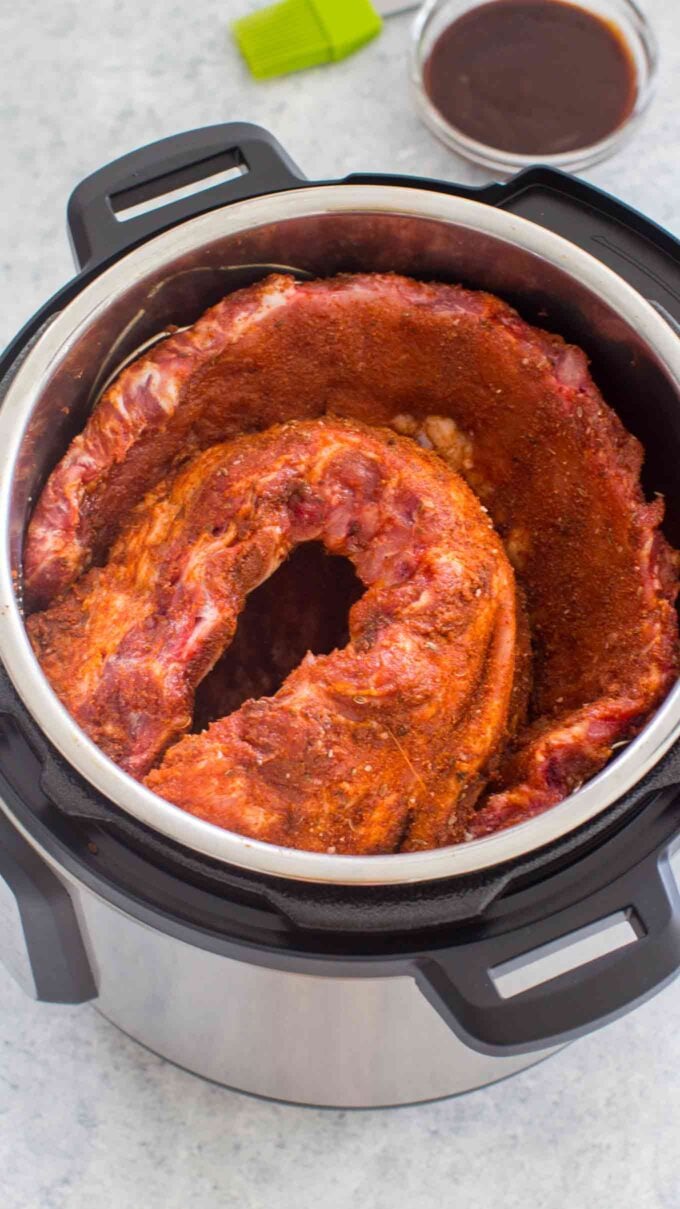 Pork ribs seasoned with herbs and a rub mixture in the instant pot