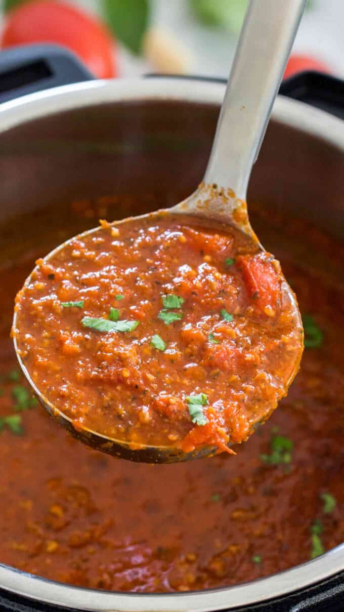 a ladle of Instant pot meat sauce on top of the pot