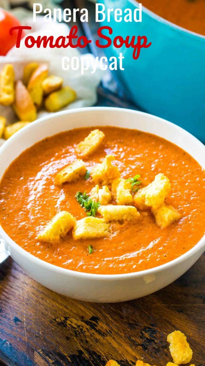 Image of homemade tomato soup topped with croutons in a white bowl.