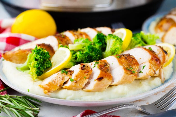 Instant pot chicken breast cooked from frozen served with mashed potatoes and broccoli.