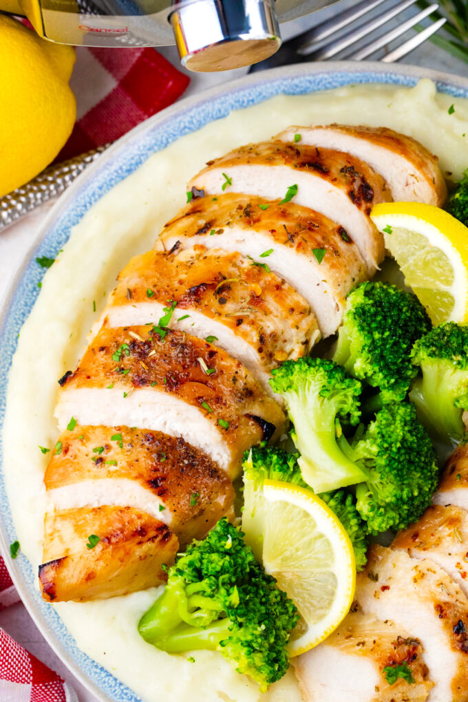 Perfectly cooked Instant pot chicken breast served with mashed potatoes and broccoli.