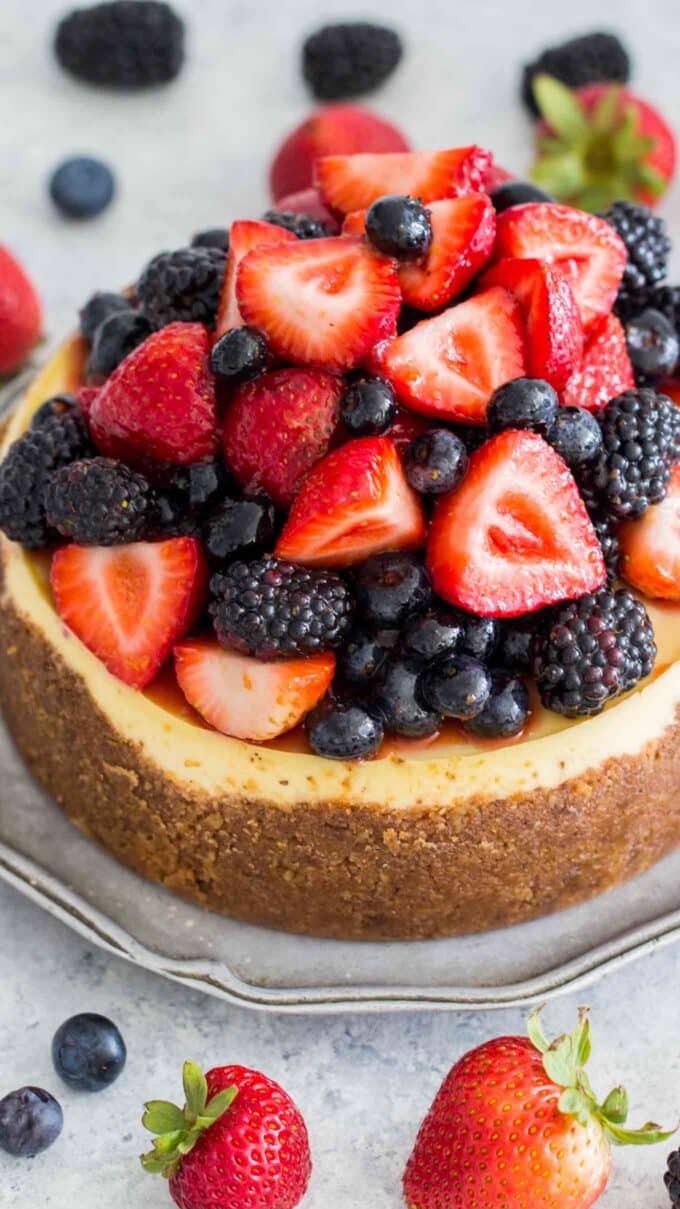 homemade New York cheesecake topped with strawberries and blackberries