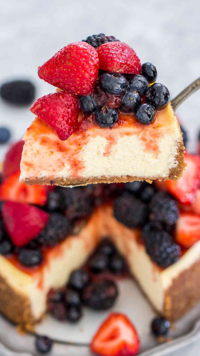 a slice of instant pot cheesecake with berry topping