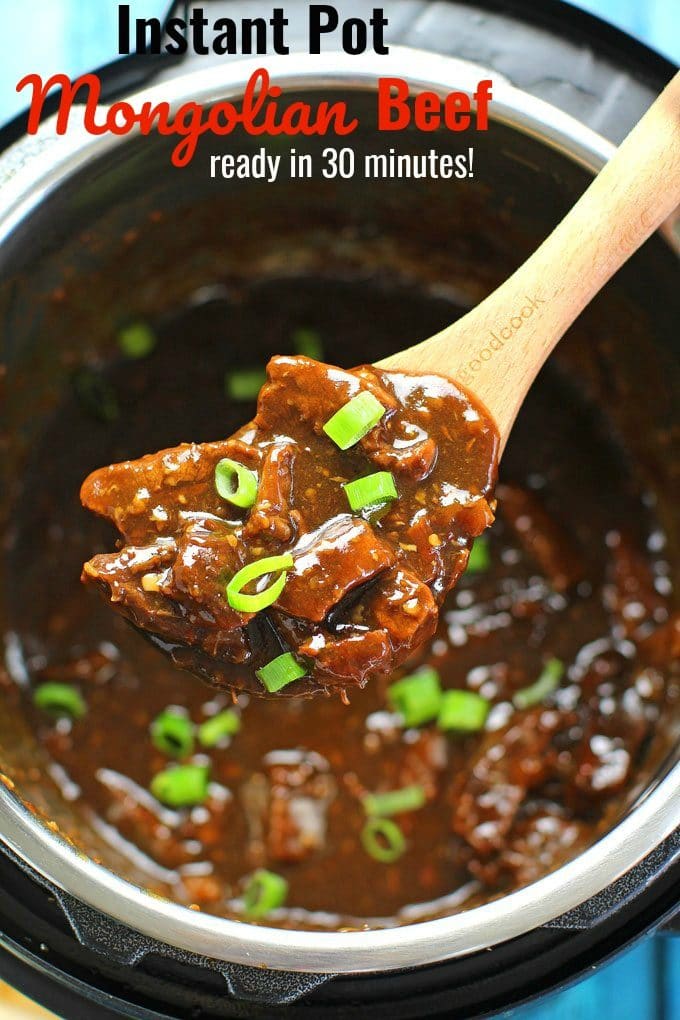 Instant pot mongolian beef garnished with chopped green onions on a wooden spoon