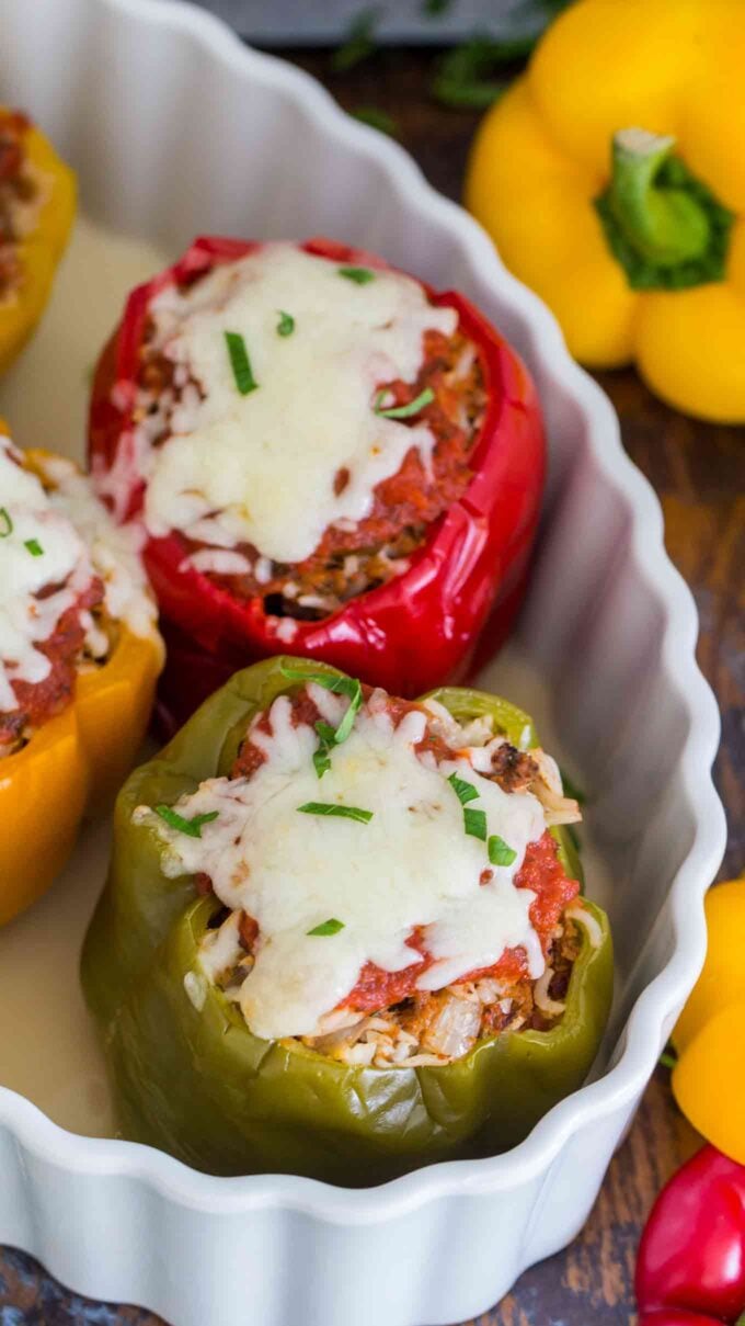 cooked instant pot stuffed peppers topped with melted cheese in a casserole dish