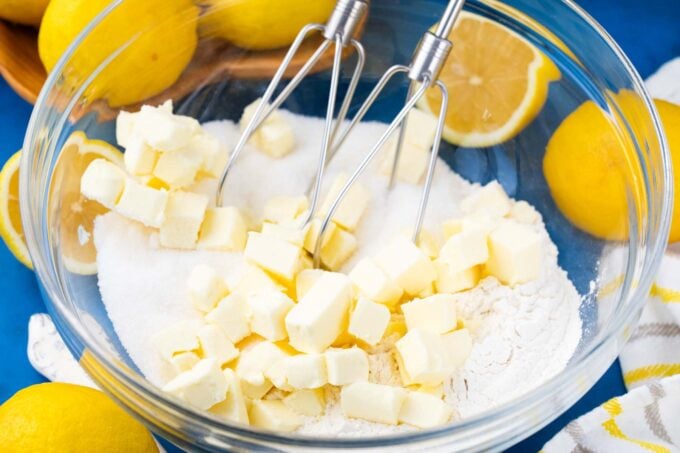 Beating butter and sugar in a bowl.