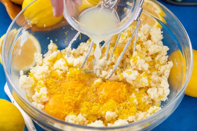 Whipping lemon brownies ingredients in a bowl.