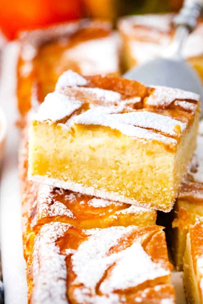 persimmon cheesecake pound cake bars on a serving spatula