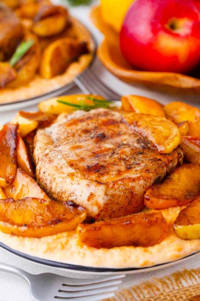 plates of apple cinnamon pork chops with cinnamon apples and mashed sweet potatoes