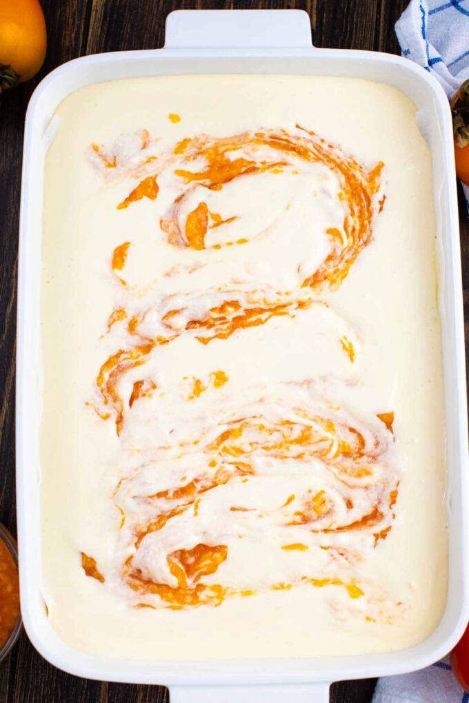 a persimmon jam swirl onto a cheesecake