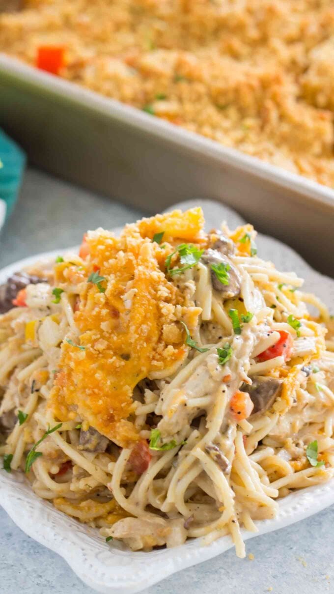 A bowl of chicken spaghetti on a white plate.