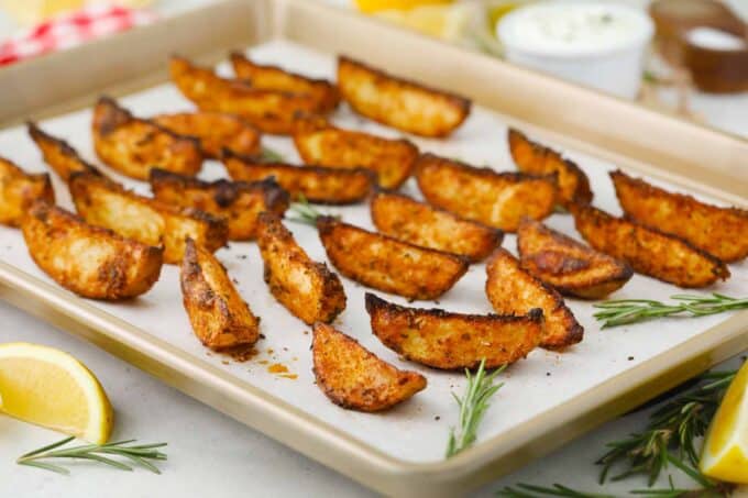 crispy baked potato wedges on a baking sheet