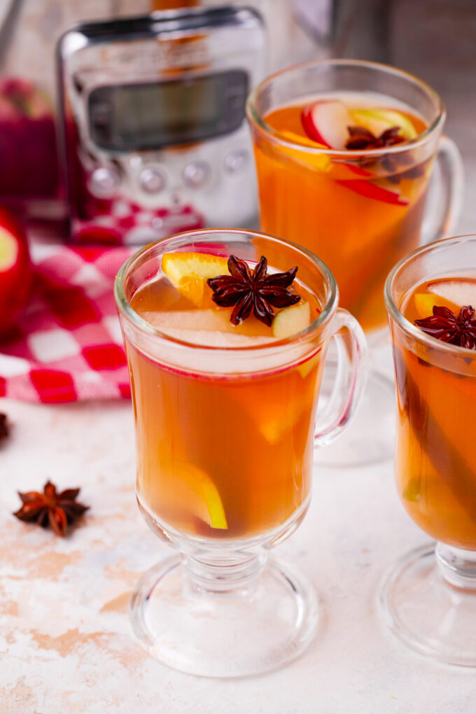 Cups of slow cooker apple cider.