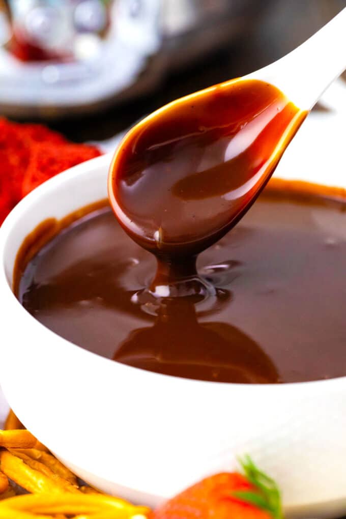 Slow cooker chocolate fondue dripping of a spoon into a bowl