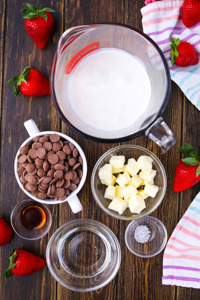 Overhead shot of slow cooker chocolate fondue ingredients in bowls on a table.