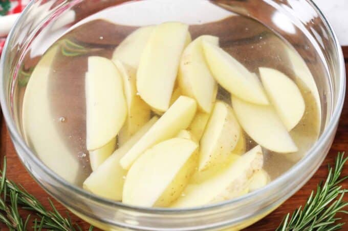 potato wedges in a bowl of water