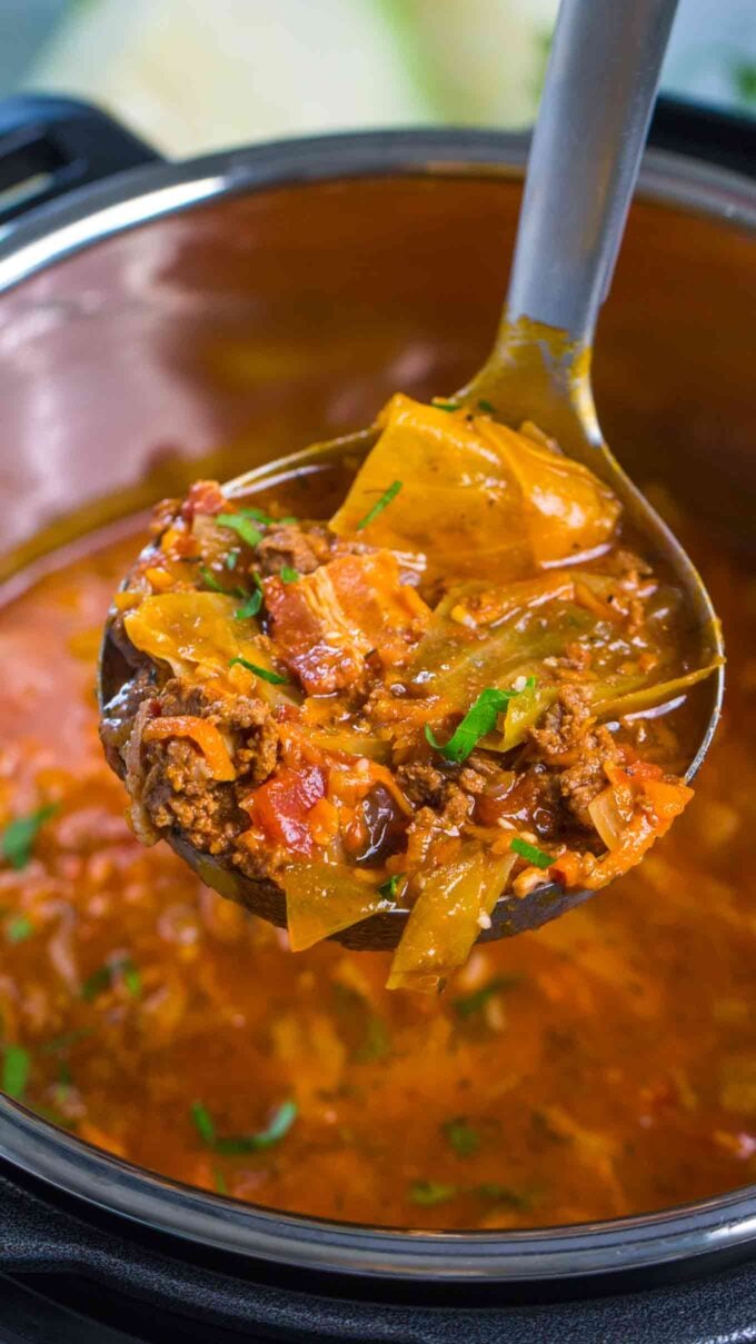 a ladle of instant Pot Cabbage Roll Soup with bacon