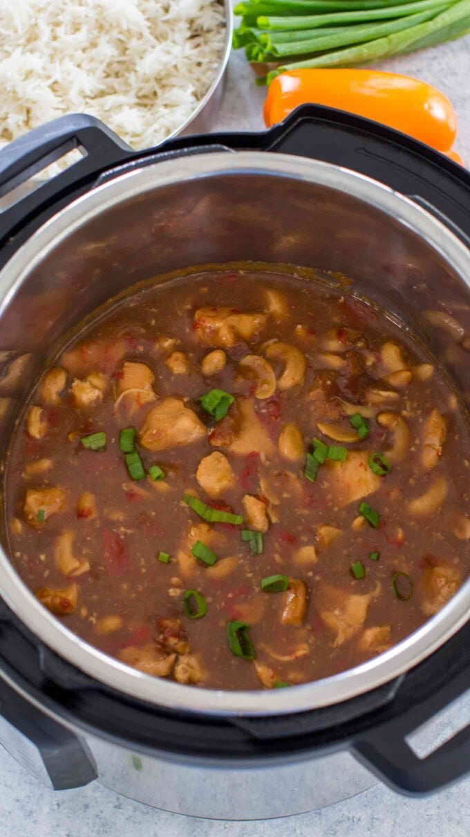 instant pot cashew chicken in the pressure cooker with rice next to it