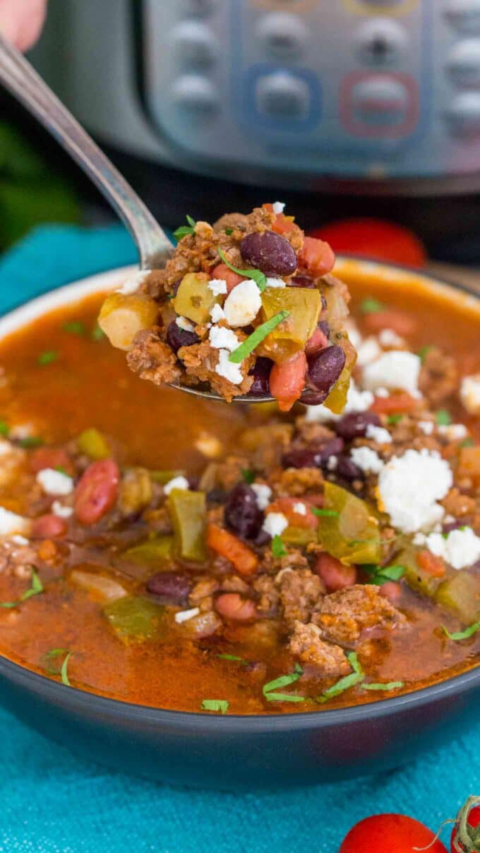 ground beef taco soup garnished with cheese