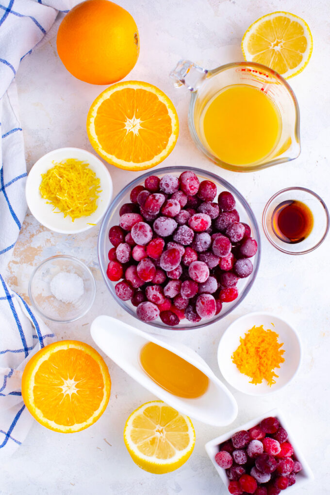 Overhead shot of Instant Pot cranberry sauce ingredients in bowls on a table.