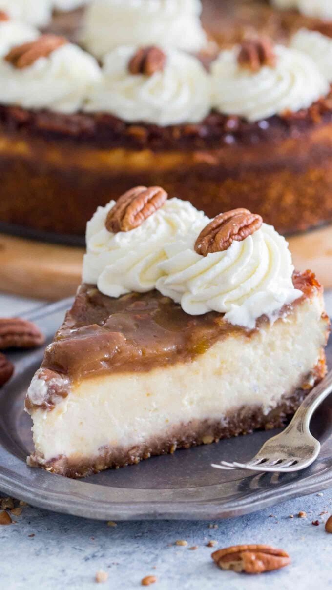 A slice of pecan Pie Cheesecake Recipe on a silver plate