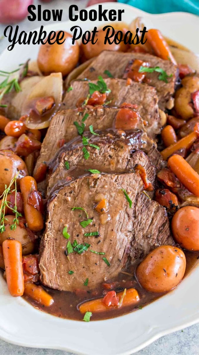 Image of Yankee pot roast with carrots and potatoes on a white plate. 