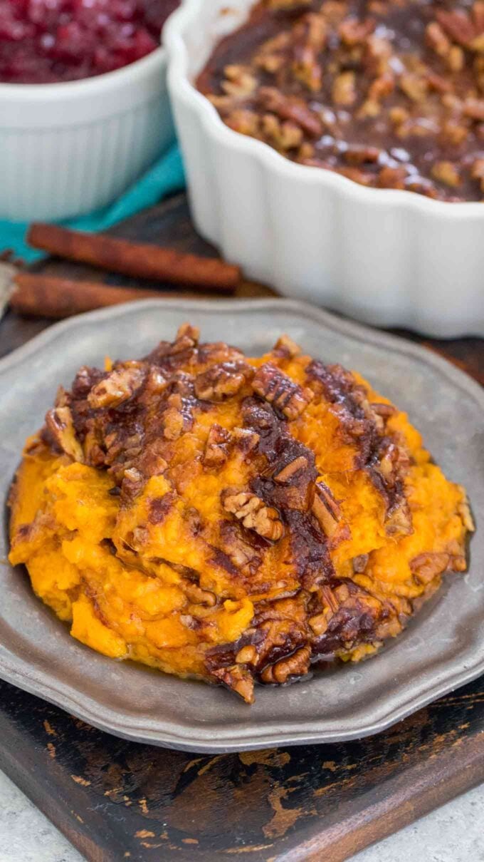 sweet potato souffle on a silver plate topped with cinnamon sugar pecans