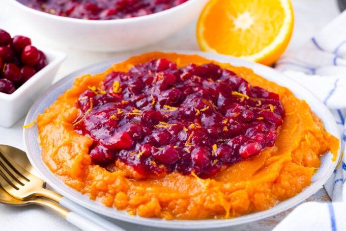 Homemade Instant Pot cranberry sauce over sweet mashed potatoes.