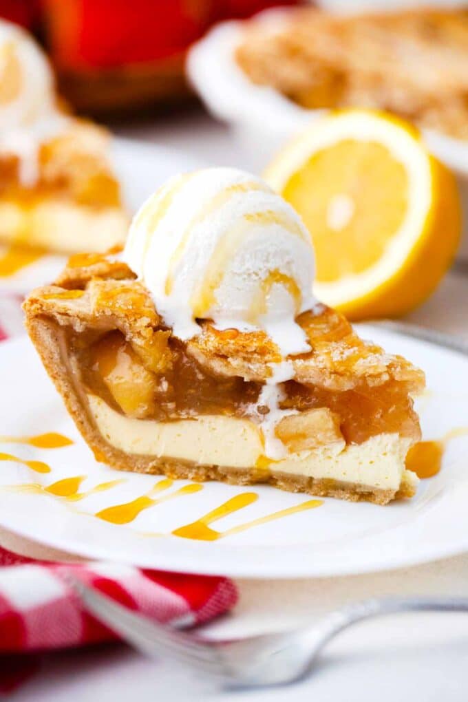 a slice of homemade apple pie topped with vanilla ice cream and a drizzle of caramel