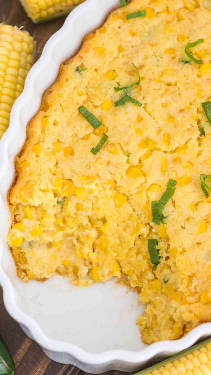 Homemade corn casserole garnished with chopped green onions.