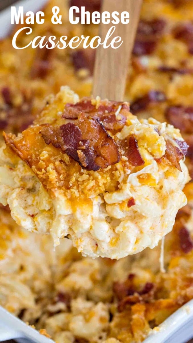 Macaroni and cheese topped with bacon crumbs scooped with a wooden spoon. 