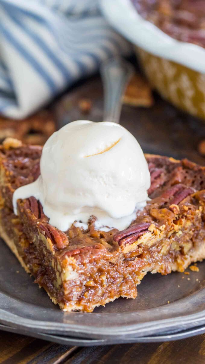 Slice of Homemade Pecan Pie topped with vanilla ice cream