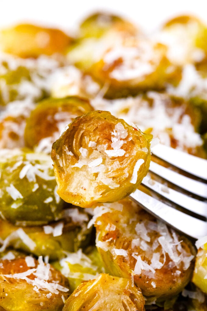 A crispy roasted Brussel sprout on a fork.