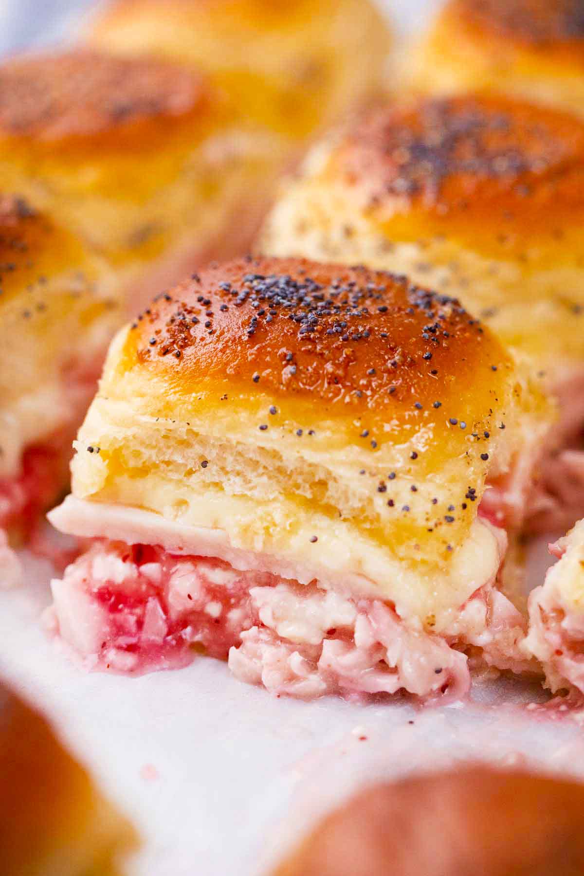 cheesy turkey sliders topped with poppy seeds